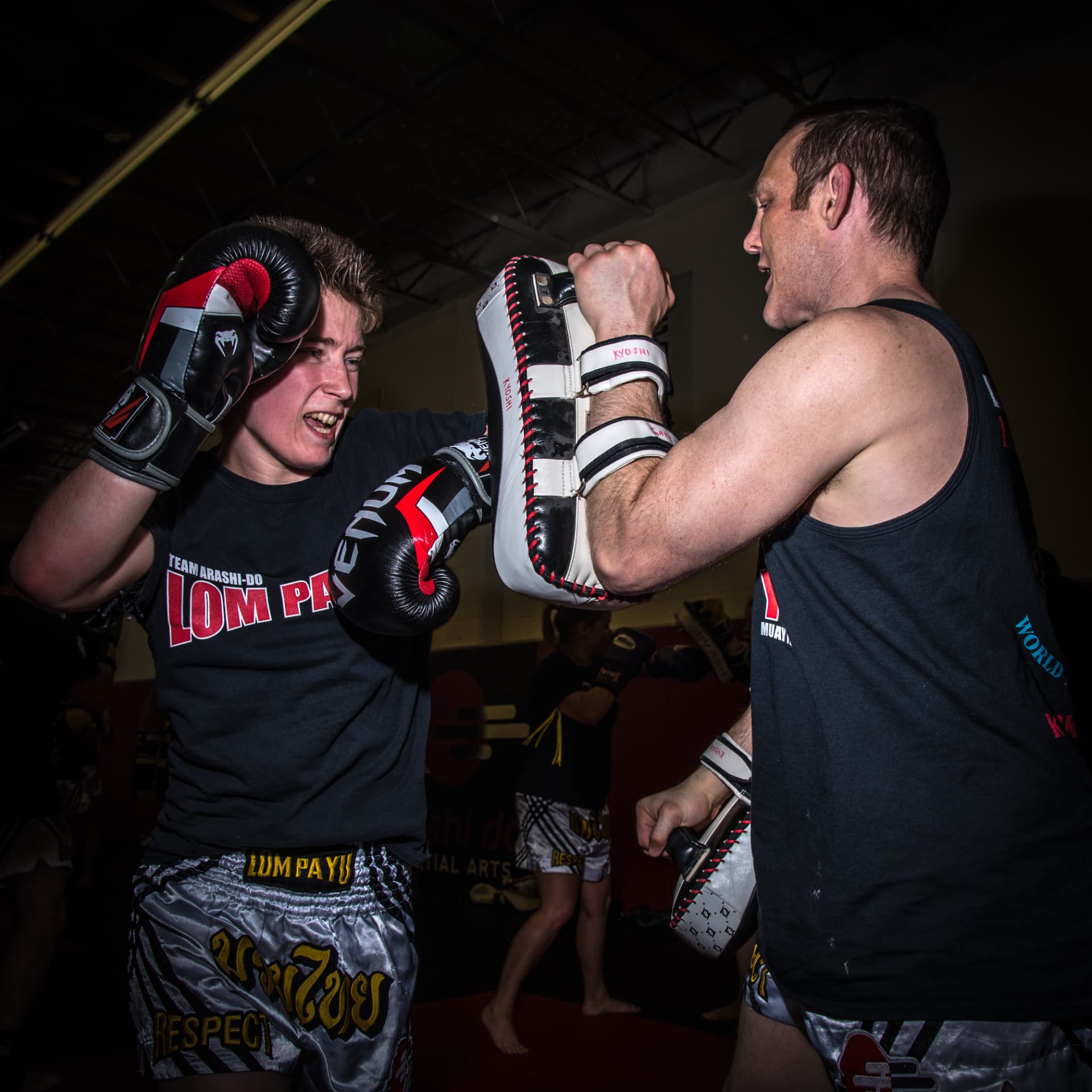 Two Arashi-Do Red Deer students working Muay Thai pads during a training session